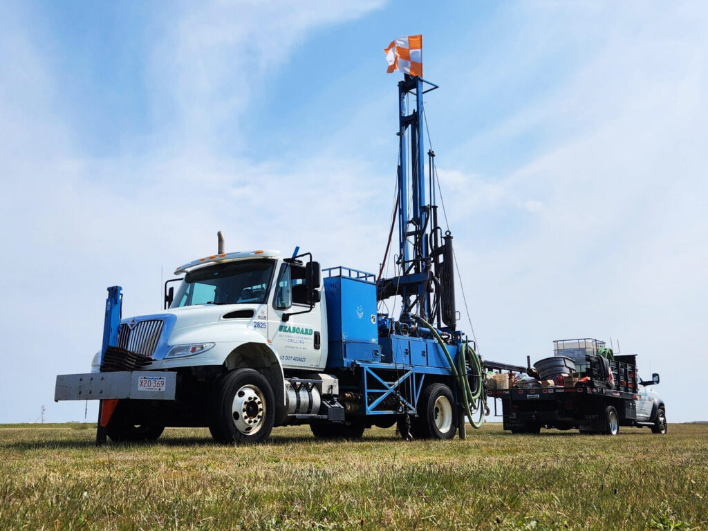 Photo of a Seaboard Drilling drill rig truck in a field.